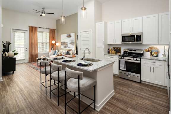 A kitchen with a dining table and chairs.