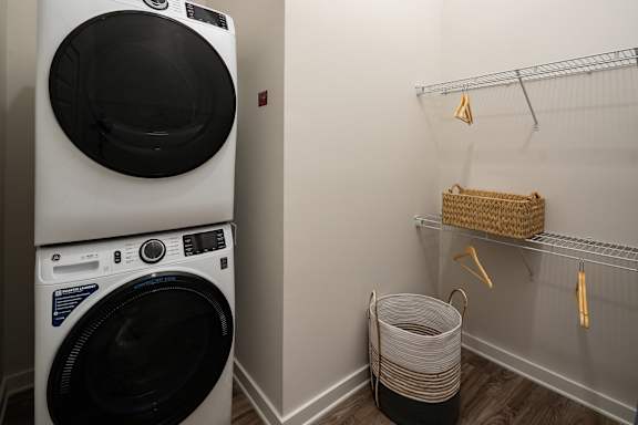A white washing machine is stacked on top of another one.