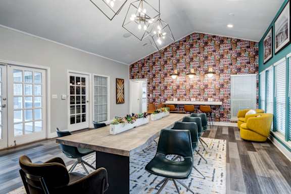 A dining room with a long table and chairs.