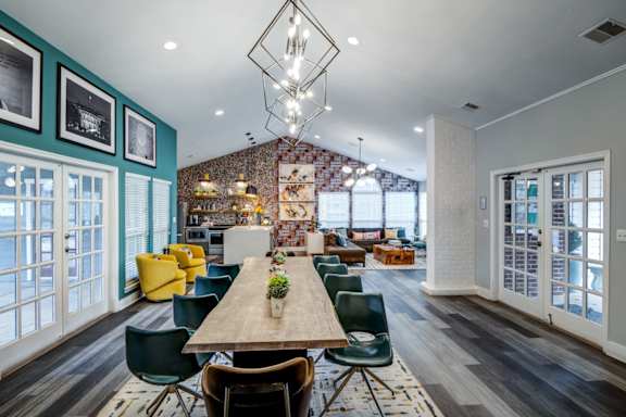 A dining room with a long table and chairs.