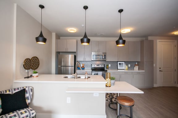 a view of the kitchen and living room in a bedroom plus den unit at the central apartments