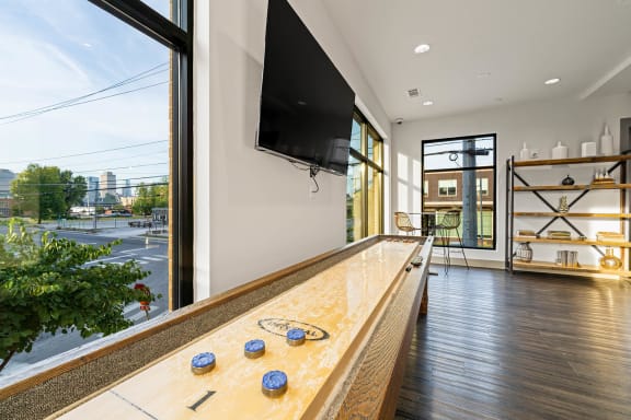 a living room with a large window and a counter with a television