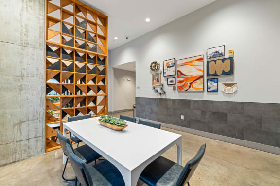 a dining room with a white table and chairs