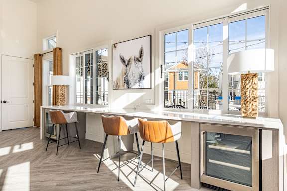 A kitchen with a table and chairs and a framed picture of a horse on the wall.