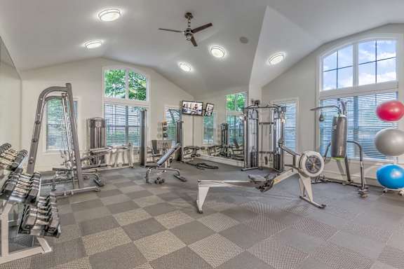 A spacious home gym with a variety of exercise equipment.