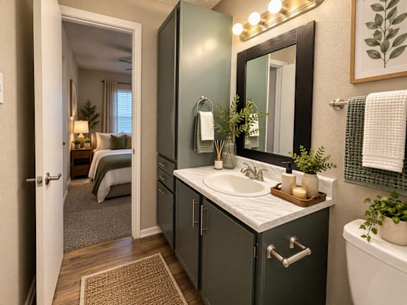 A bathroom with a sink, mirror, and a towel rack.