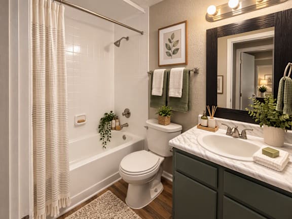 A bathroom with a white toilet, a white sink, and a white bathtub with a white shower curtain.