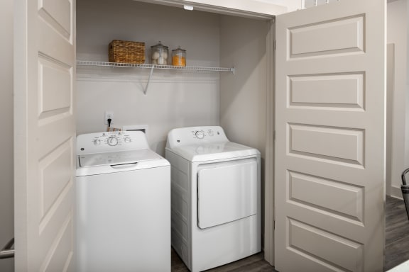a small laundry room with two washes and a dryer