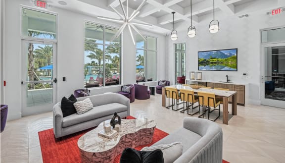 a living room with two couches and a table with chairs at Altis Grand Lake Willis, Orlando, 32821