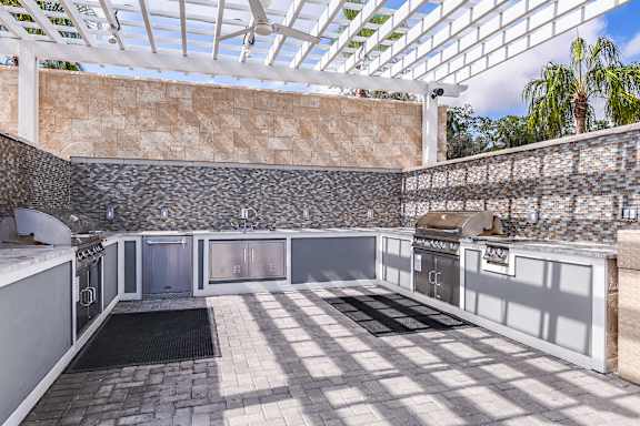A kitchen with a glass roof and stone walls.