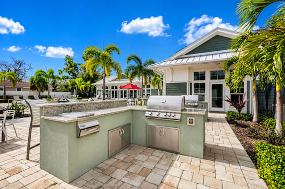 A patio with a built-in grill and barbecue area.