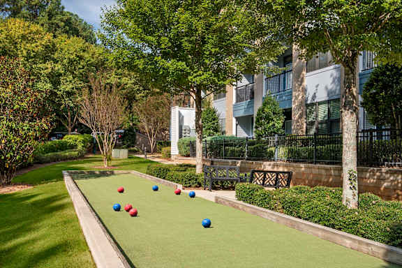 A lawn with a row of red, blue, and white balls.