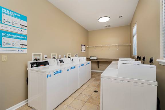 A laundromat with rows of washers and dryers.
