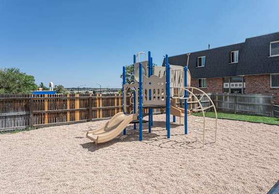 A playground with a slide, swings, and a climbing frame.