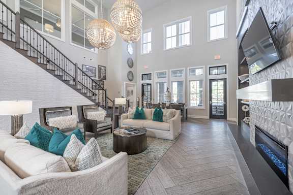 A living room with a staircase and a fireplace.