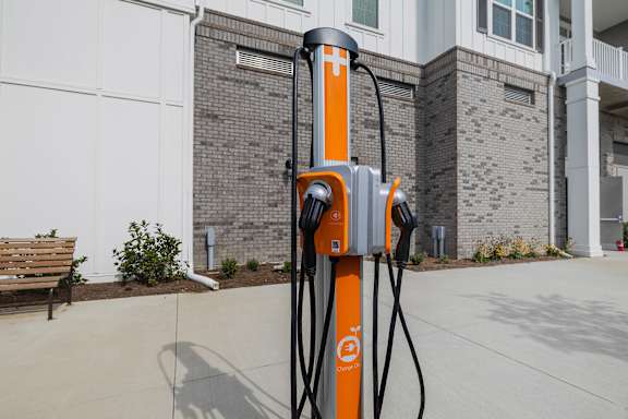 A charging station for electric vehicles is orange and black.