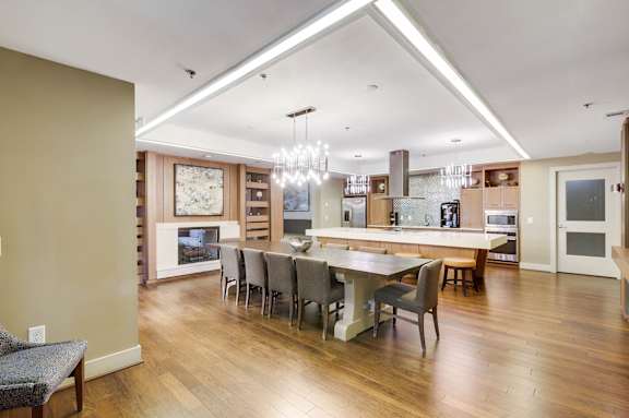 A modern kitchen with a dining table and chairs.