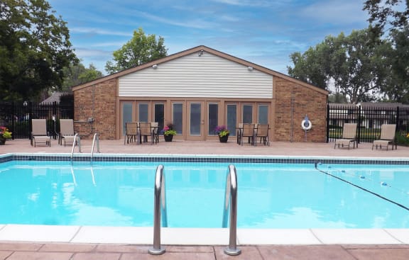 a brick building with a pool in front of it at Forest Glen, Midland, Michigan