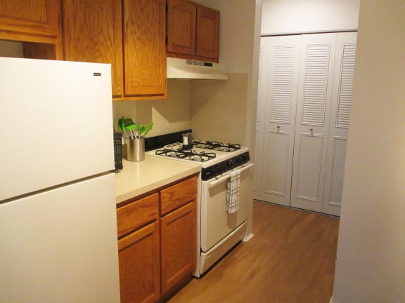 a kitchen with a white refrigerator freezer next to a stove top oven  at Forest Glen, Midland, Michigan