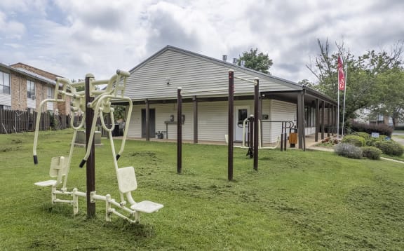 a yard with a swing set in front of a house