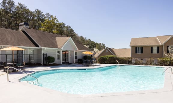 a swimming pool with apartments in the background