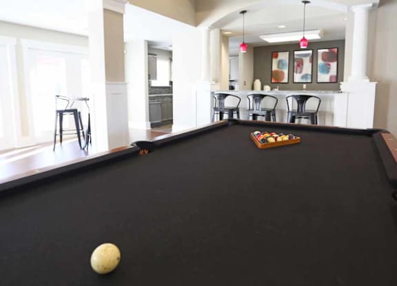 A pool table with a white ball on it.