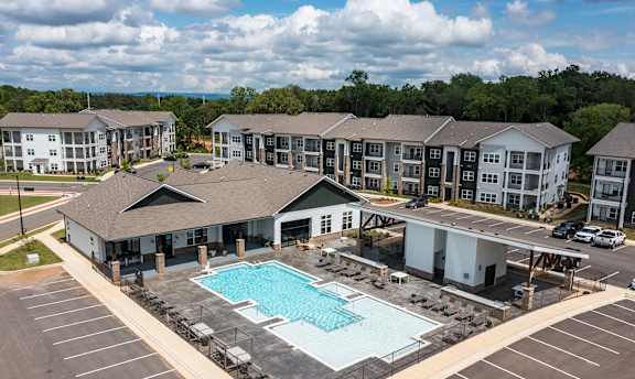 A large building complex with a pool in the foreground.