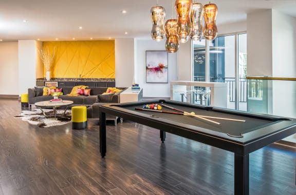 a living room with a pool table and a couch
