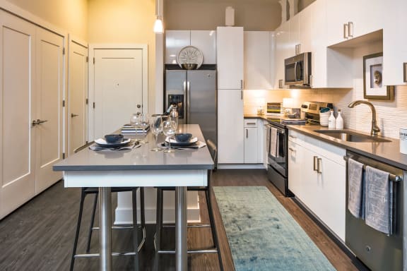 a kitchen with stainless steel appliances and a blue counter top