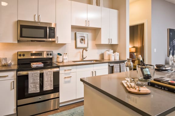 a kitchen with stainless steel appliances and white cabinets