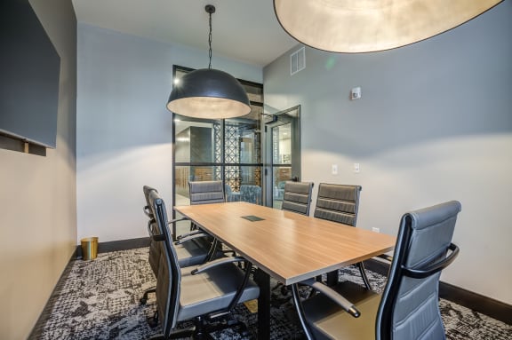 a meeting room with a table and chairs