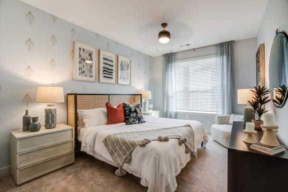 a bedroom with a large bed and a window
