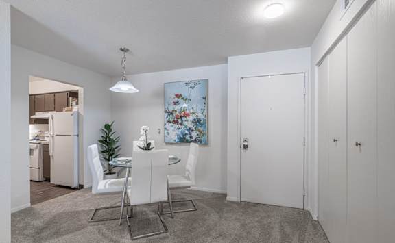 A dining area with a table and chairs is shown at Winchell Way Apartment , Kalamazoo, Michigan