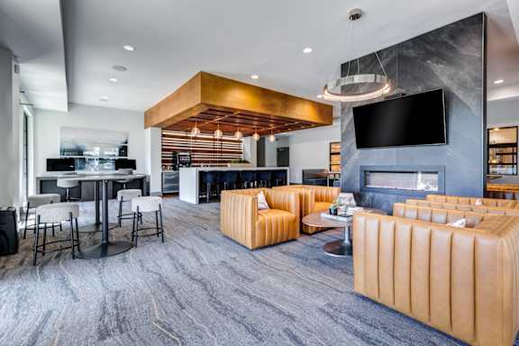 A modern living room with a large television and comfortable seating.