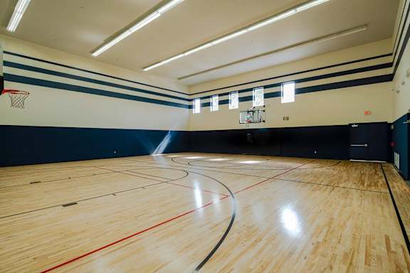 a basketball court in an empty gym with wood floors