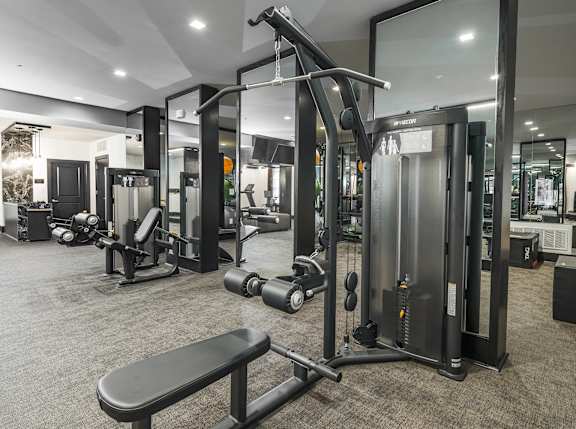 A gym with a variety of equipment including a leg press machine.