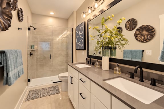A bathroom with a sink, mirror, and toilet.