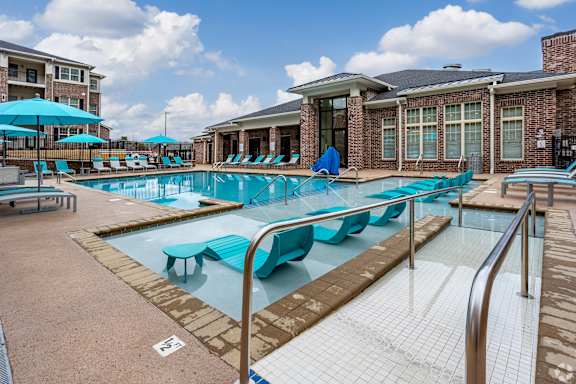 our apartments have a resort style pool with lounge chairs and umbrellas