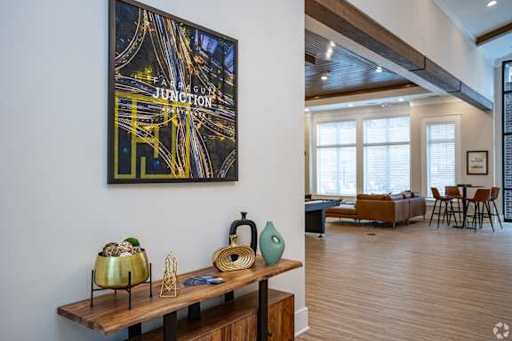 a living room with a table and a painting on the wall