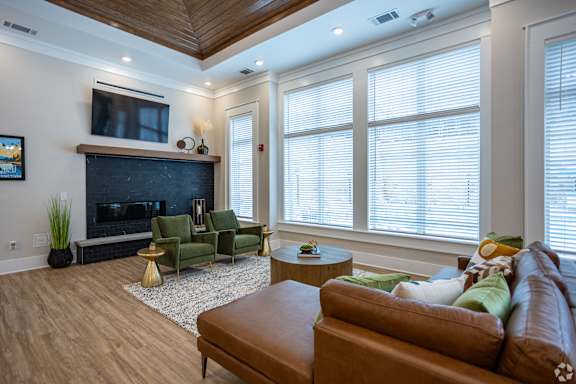 a living room with a leather couch and a fireplace