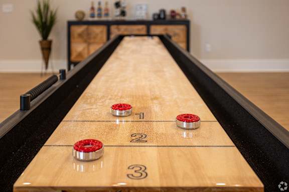 a shuffleboard game table in a living room