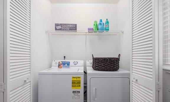 A small laundry room with a washer and dryer.