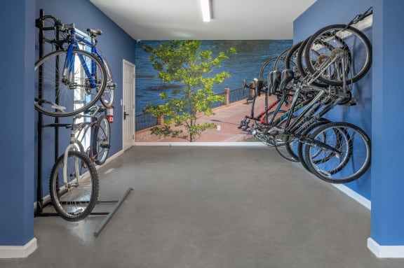 a room with a row of bikes hanging on the wall