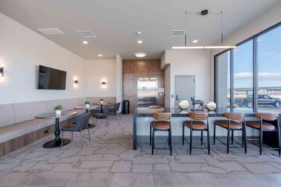 A modern dining area with a long table and chairs.