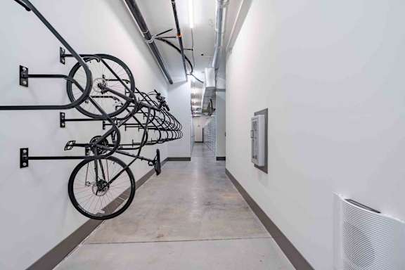 A hallway with bicycles hanging on the wall.