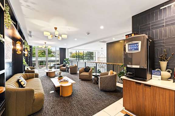 A modern living room with a balcony overlooking the outdoors.
