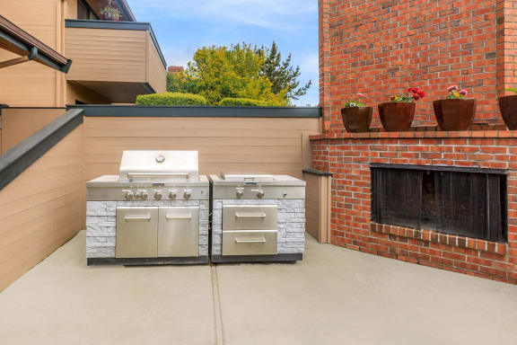 a backyard with a barbecue grill and a fireplace