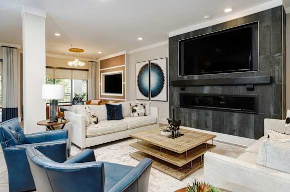 A modern living room with a fireplace and a large TV.