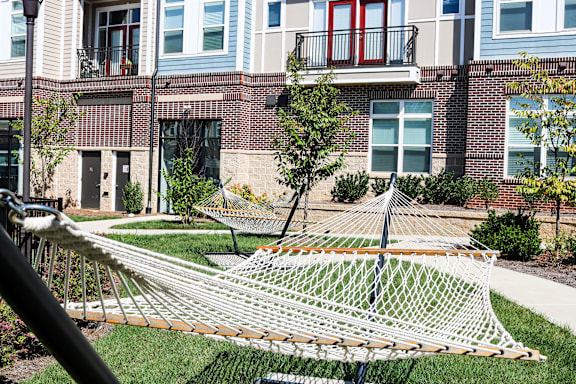 A white net is in the grass in front of a building.