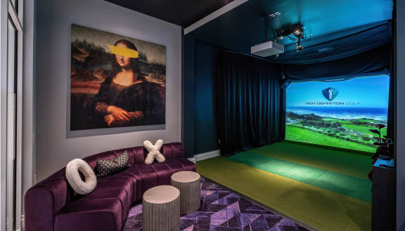 a home theater with a purple couch and a painting on the wall at Altis Grand Lake Willis, Florida